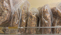 Dried crayfish in large clear bags on shelf