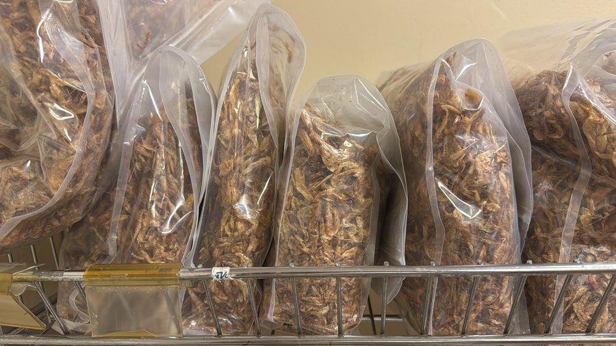Dried crayfish in large clear bags on shelf