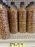 Roasted groundnuts in clear plastic bottles on shelf priced at $9.99