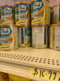 Peak Instant Whole Milk Powder cans on shelf